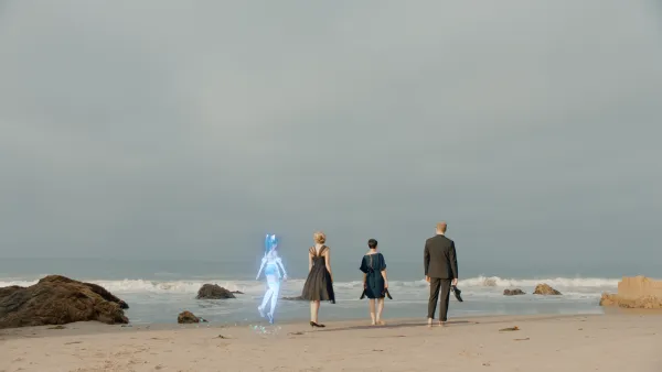 Four characters walk with one's back turned in the beach in a grey day. The character on the left is a blue anime that floats on the air; a blonde woman with an elegant black dress; a woman with a green dress holding her shoes and a bald man in a suit, also holding his shoes.